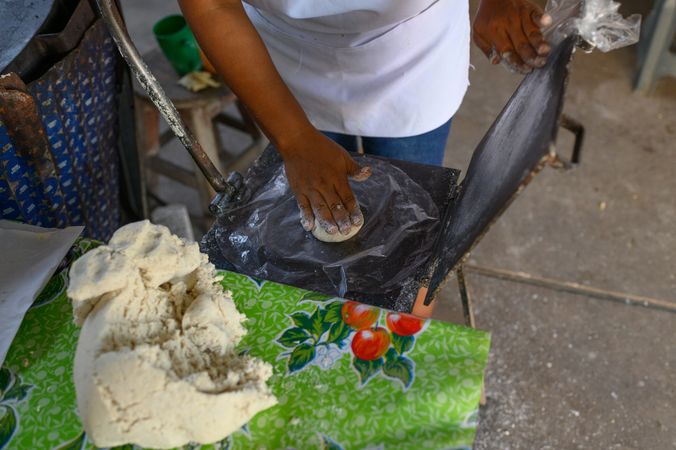 Crop ethnic woman preparing dough