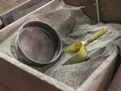 Metal strainer and plastic scoop on dry material