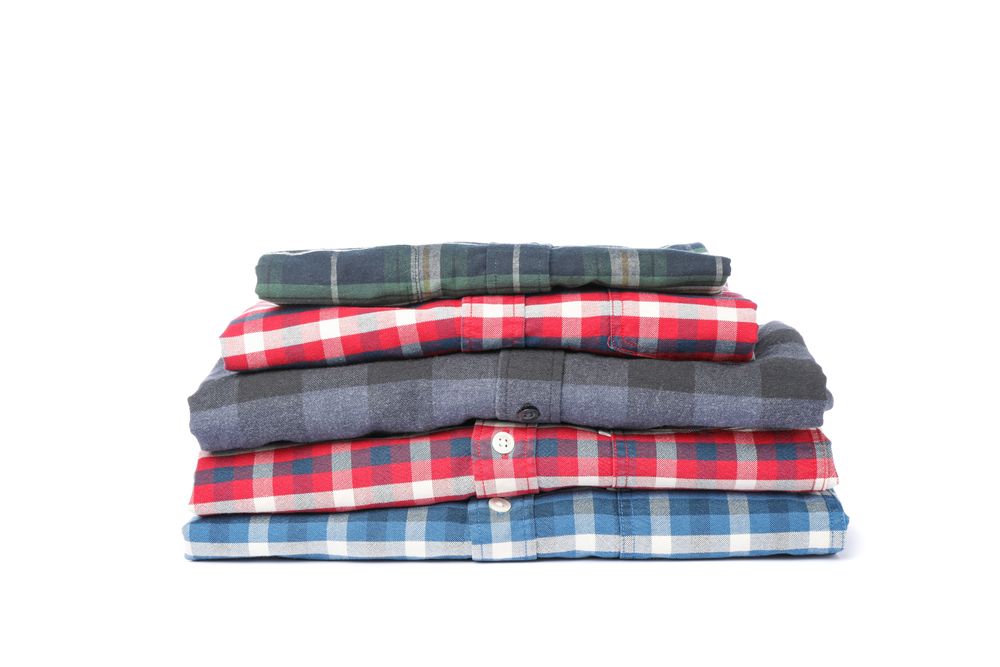 Folded checkered shirts isolated on blank background