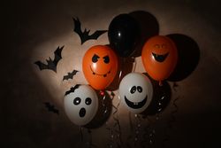 Different balloons on dark background. Halloween concept