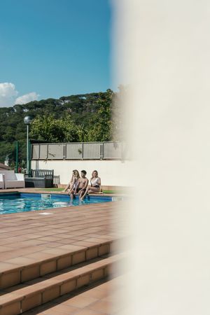 Group of friends sunbathing by the pool