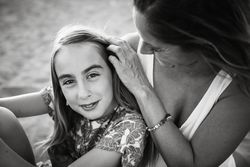 Woman with daughter on sunny beach