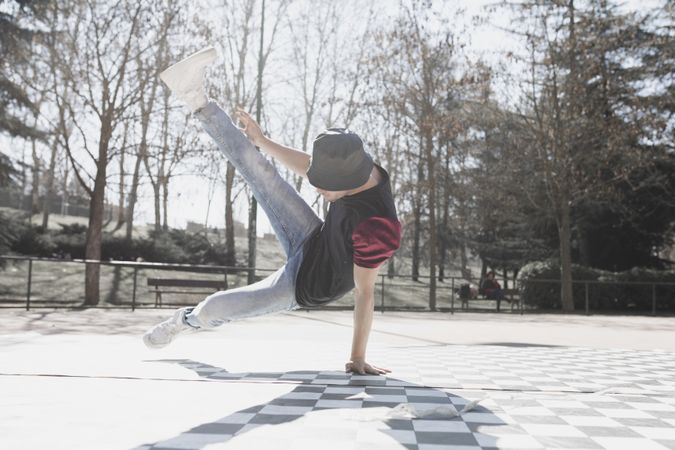 Man dancing break dance in park