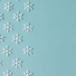 Winter pattern made of uniform snowflakes on blue background