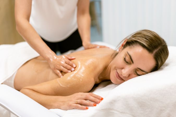 Woman having her back massaged in a salon