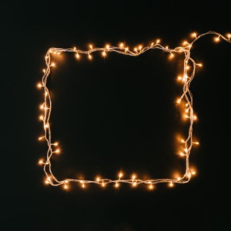 Fairy lights or Christmas lights in square shape on dark background