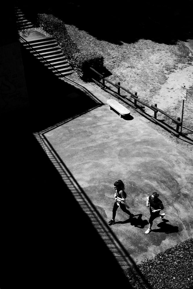 Looking down at man and woman going for a run in public park
