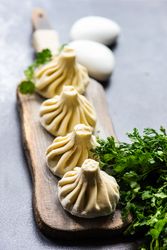 Serving of Georgian khinkali dumplings with cilantro garnish