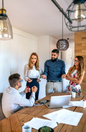 Businesspeople asking for explanations to a employee