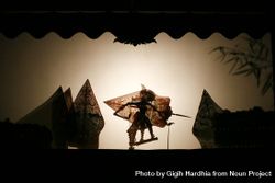 Layered shadow puppet figure with shield bY1AYb