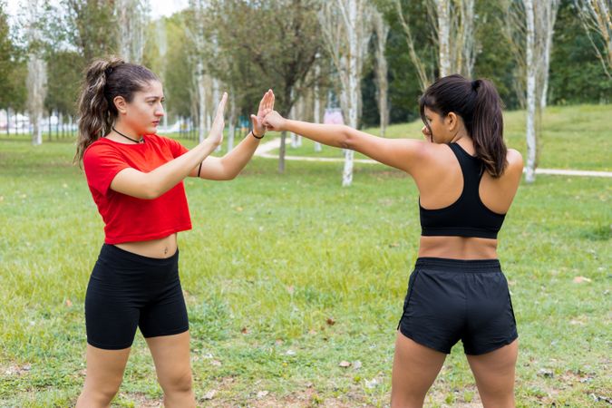 Female boxers training boxing sparring and punching  outdoors