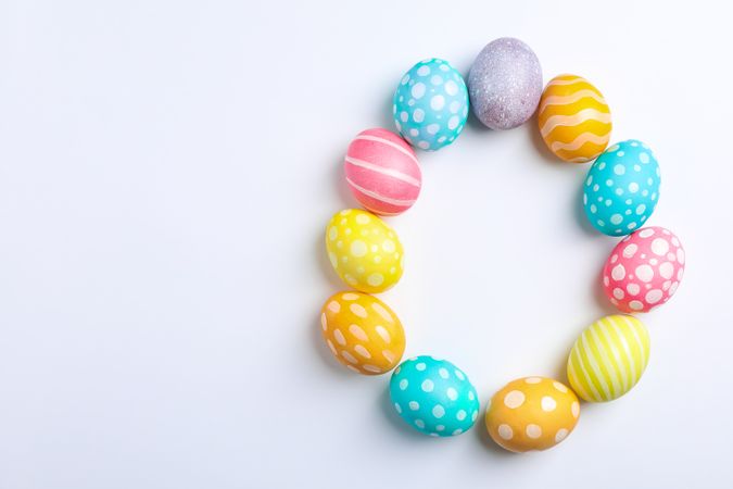Decorative Easter eggs on neutral background, space for text. Top view