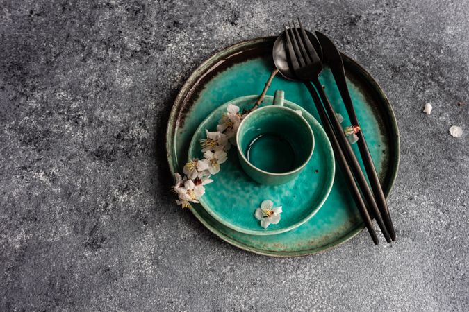 Spring floral concept with teal plates with apricot blossom