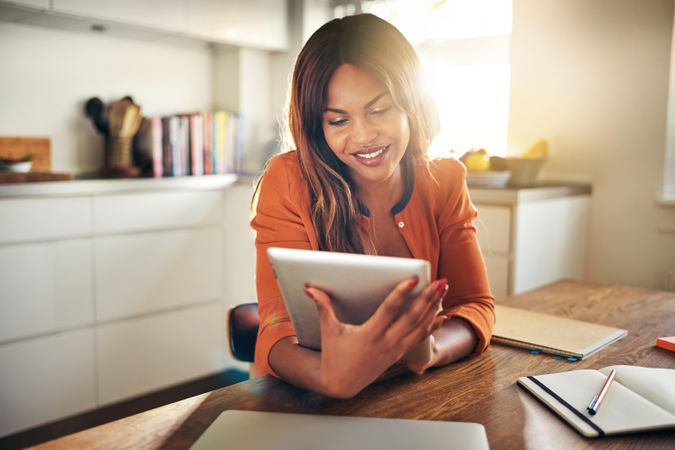 Businesswoman smiling at her tablet screen