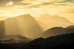 Majestic mountain in sunbeams under cloudy sky