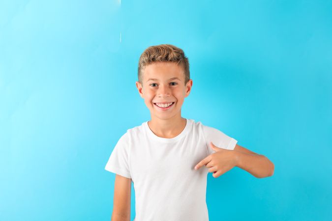 Boy in t-shirt against color background, space for text