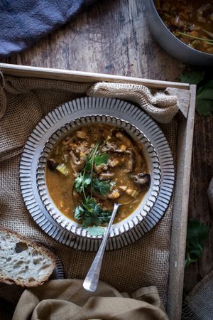 Bread and parsley near quinoa soup
