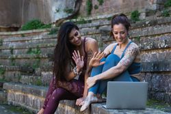 Content diverse women having yoga lesson via laptop