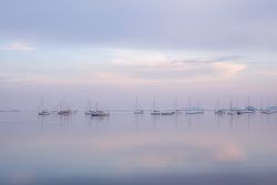 Boats on calm sea water in evening