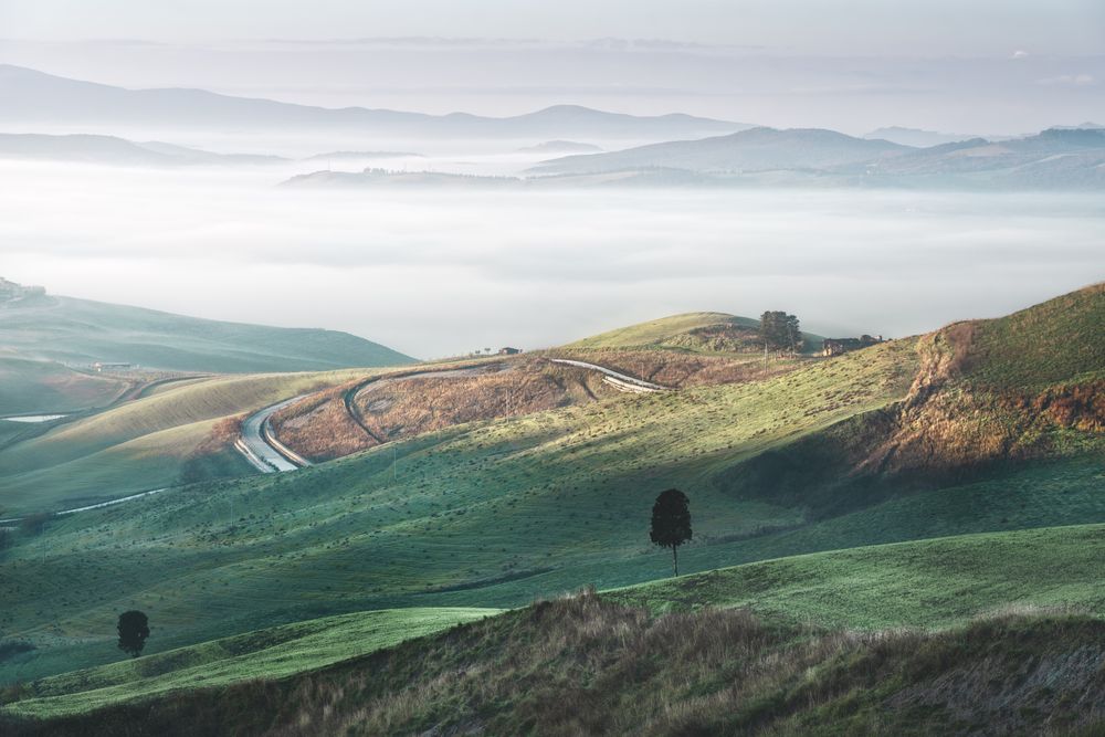 Foggy landscape in Volterra at sunrise, Tuscany, Italy
