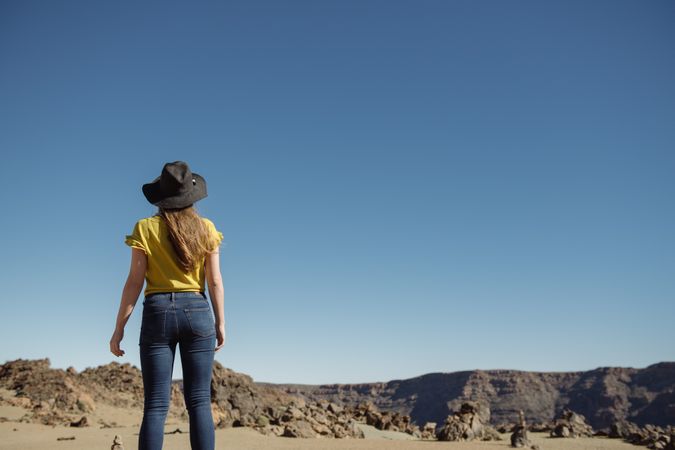 Woman standing against blue sky