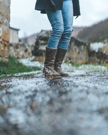 Man walking on wet autumn trail