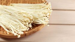 Bamboo basket of fresh golden needle mushrooms