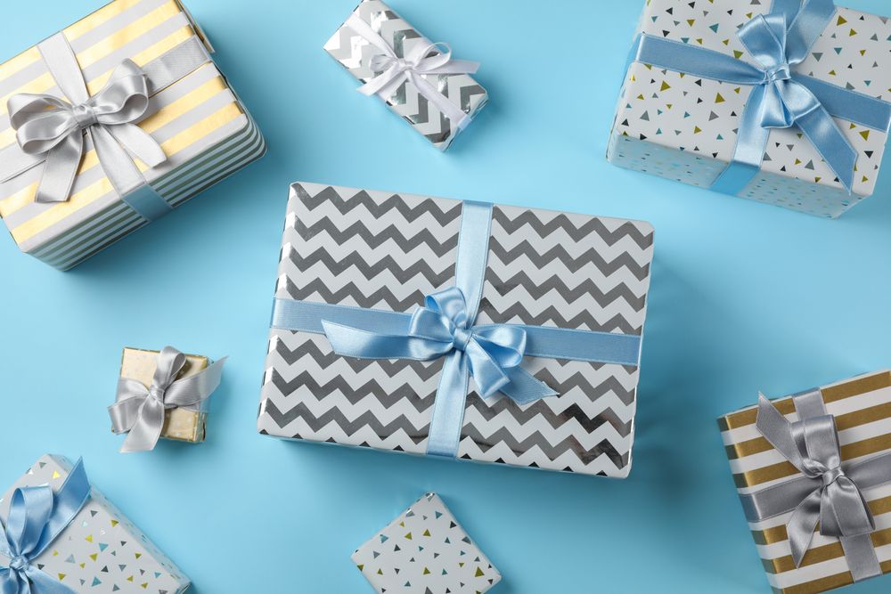 Different gift boxes on blue background, top view