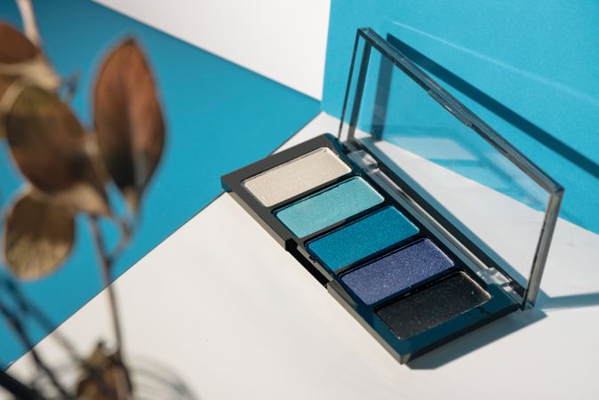 soft blue eyeshadow palette on geometric background.