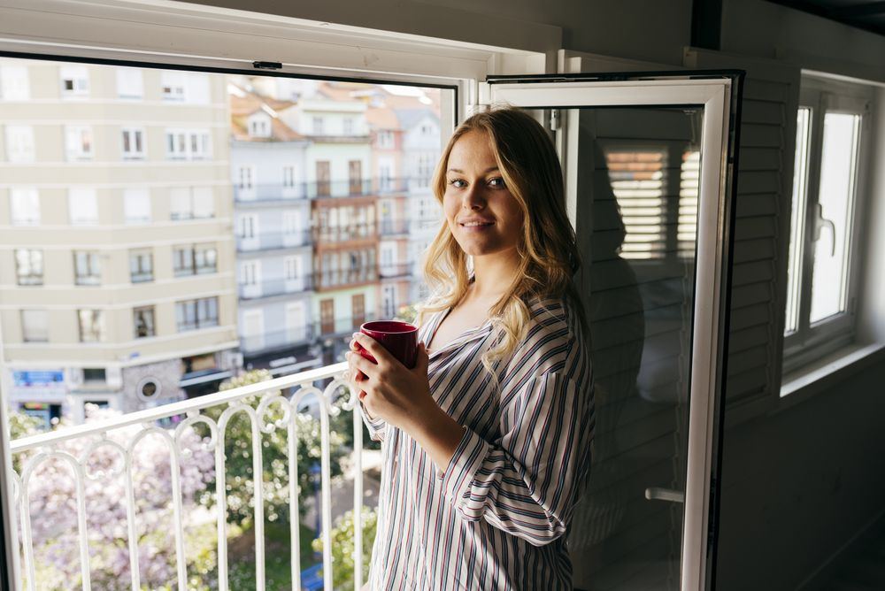 Young woman with cup looking at camera