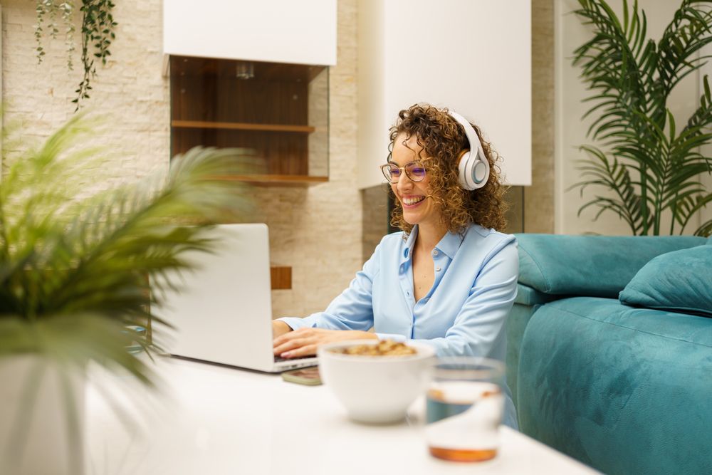 Happy woman sitting on video call at home