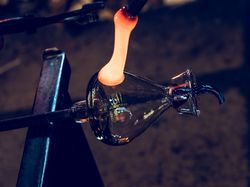Craftsmen making glass bottle in factory