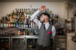 Bartender flaring a bottle at the bar