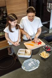 Mother preparing healthy snack for her daughter for school
