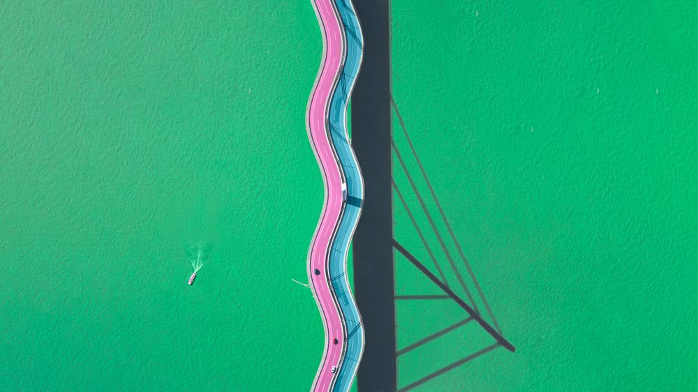 Minimal drone photo of a funky looking bridge