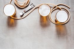 Top view of beer on table with bottle opener and rope