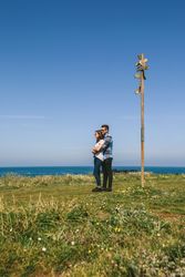 Couple embraced by a direction sign