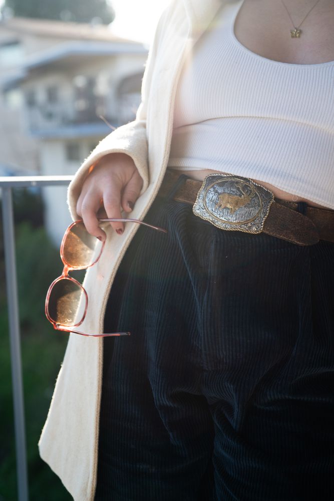 Cropped shot of woman’s torso wearing fashionable outfit