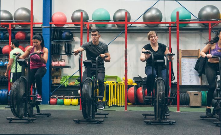Athletes doing air bike indoor