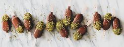 Ice cream chocolate pistachio popsicles, light background, top view, wide composition