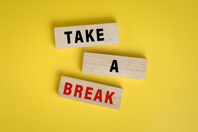 take a break words on wooden blocks isolated on yellow background