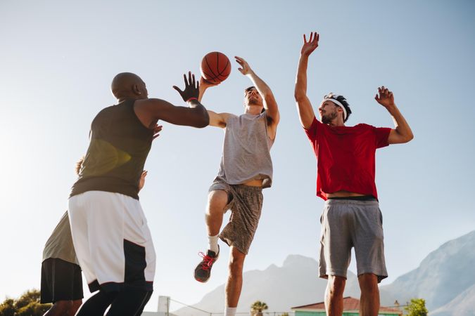 Men practicing basketball dribbling skills