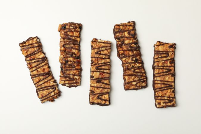 Tasty granola bars on plain background, top view