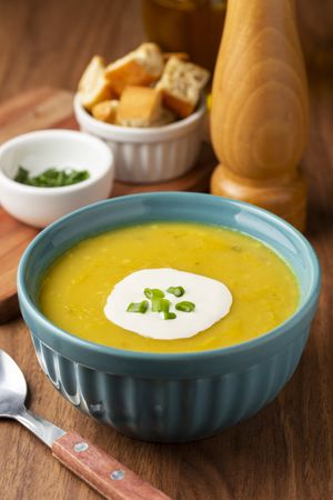 Bowl with pumpkin soup on the table.