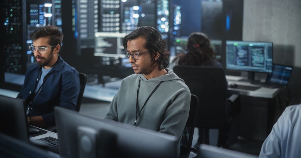 Portrait of a Indian Engineer Working on Desktop Computer in a Technological Office Environment.