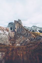 Man standing on rock formation on a mountainous landform in Italy 0P2Q24