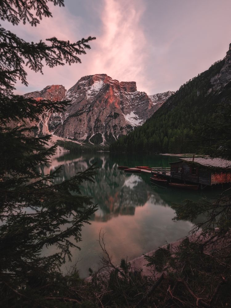 Houseboat surrounded with mountains on serene lake