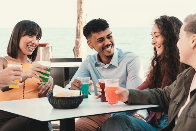 Friends Chatting on Beachfront Terrace