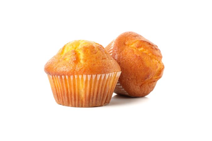 Delicious tasty muffins isolated on light background