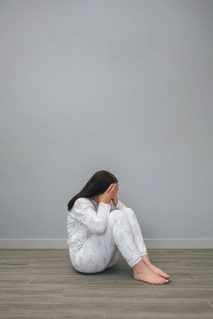 Woman covering her face with hands